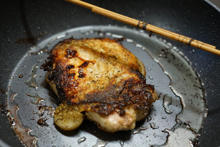 Pork fried in a frying pan. At home. The view from the top.