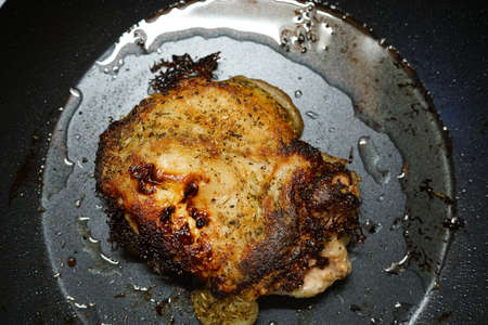 Pork fried in a frying pan. At home. The view from the top.の写真素材