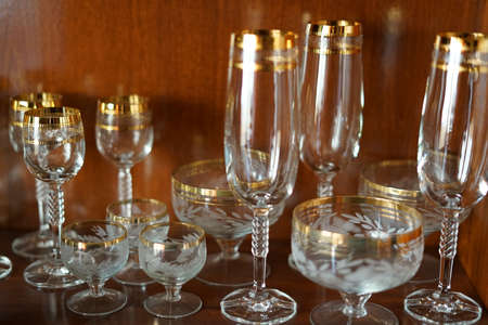 Glass holiday tableware in a mahogany Cabinet.の写真素材