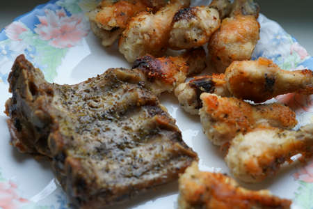 Fried chicken wings and fried ribs. On the plate.の写真素材