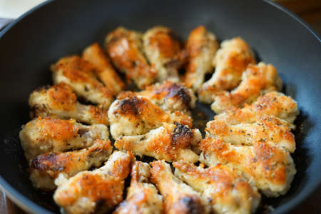 Fried chicken wings. Golden color. In a pan.の写真素材
