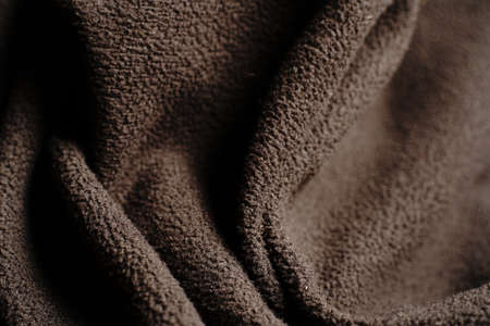 Textile black texture that goes in waves. Dim lights.の写真素材