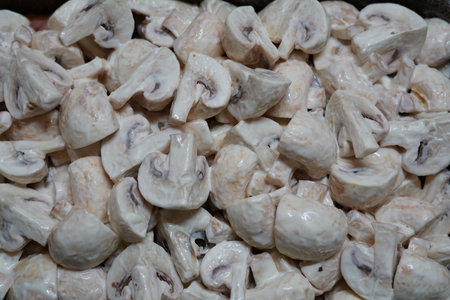 Mushrooms in mayonnaise in a baking dish. Prepared to be sent to the oven. Cooking a festive dinner in the oven.の写真素材