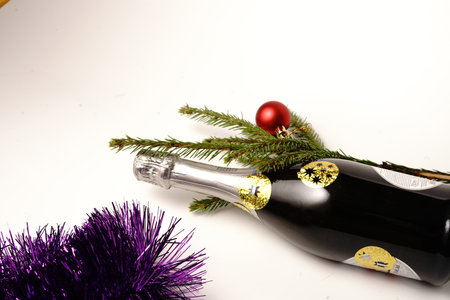 A bottle of champagne and a Christmas tree branch.の写真素材
