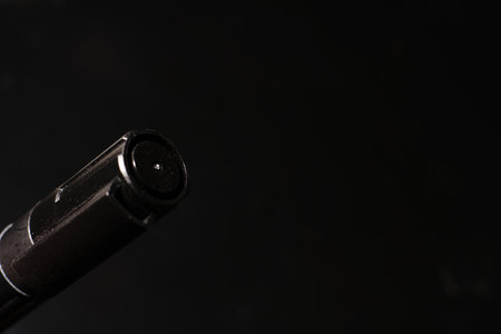 Black permanent marker on a black background. The cap is visible.の写真素材