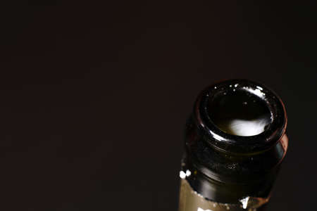 The top of a champagne bottle on a black background. Closeup. Visible smoke from the gases.の写真素材