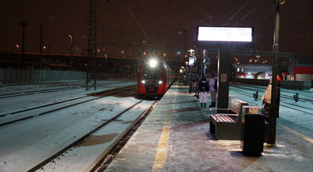 Moscow, Russia - february 16 2021: The arriving train of the Moscow Central Diameters and its bright...