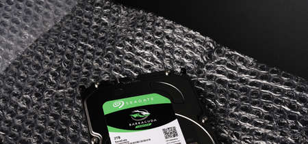 Moscow, Russia - march 3 2021: Branded hard drive for a personal computer on a black background. Storage for text and media files. Metalのeditorial素材