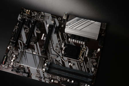 Moscow, Russia - march 3 2021: Modern branded Motherboard PC on a black background. Top view. Dimmed lightsのeditorial素材