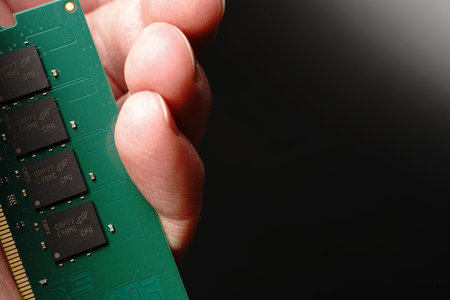 Moscow, Russia - march 3 2021: In hand is a brand-name bar of RAM for 16 gigabytes of DDR4 for PC. On a black background. Closeのeditorial素材