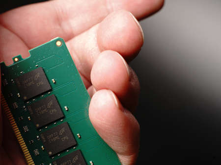Moscow, Russia - march 3 2021: In hand is a brand-name bar of RAM for 16 gigabytes of DDR4 for PC. On a black background. Closeのeditorial素材