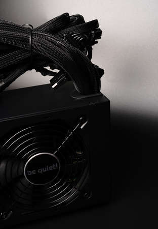 Moscow, Russia - march 3 2021: Branded 700-watt personal computer power supply on a black background. Space for textのeditorial素材