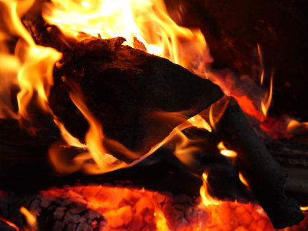 The campfire is close. Burning wooden boards. Night and total darkness