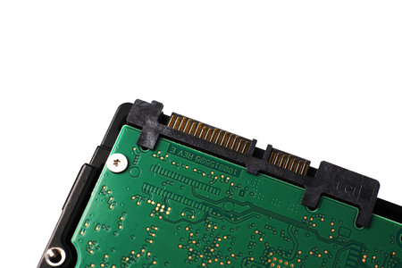 Part of a Sata hard drive for storing information on a white background with space for text. Closeup