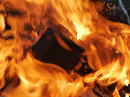 The texture of a burning campfire is close. You can see the wood and the flamesの写真素材
