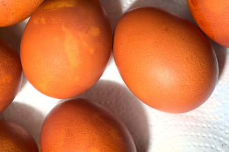 Chicken eggs painted in brown caramel color for Easter. Closeup. Top view