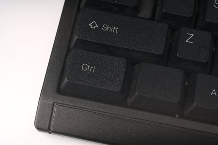 Black computer keyboard for closeup desktop computer.