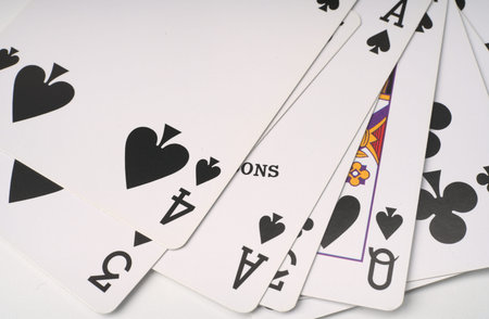 Closeup playing cards on a white background. Only the black suit. Space for text
