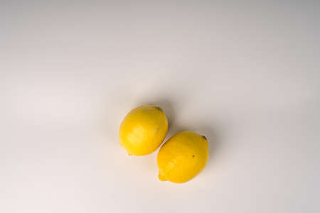 Two lemons on a white flatlay background.の写真素材