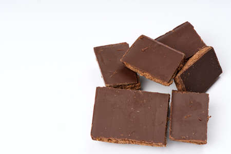 Pieces of closeup chocolate on a white background.の写真素材