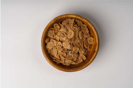 A bowl with corn flakes breakfast on a white background.の写真素材
