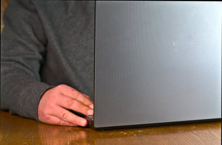 Work from home by remote work. The laptop and hands are visible