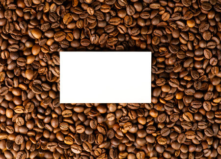 A texture of roasted coffee beans with a white card in the middle for text.