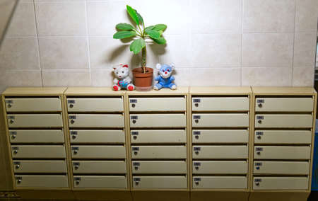 Moscow, Russia - october 27 2021: Typical mail lockers with apartment numbers in the entrance of a residential building. There is a flower and toys on topのeditorial素材