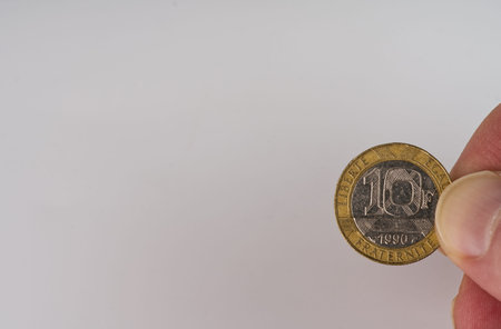 MOSCOW, RUSSIA-November 17, 2021: A coin of ten Belgian francs in a hand of the 1990 model on a...