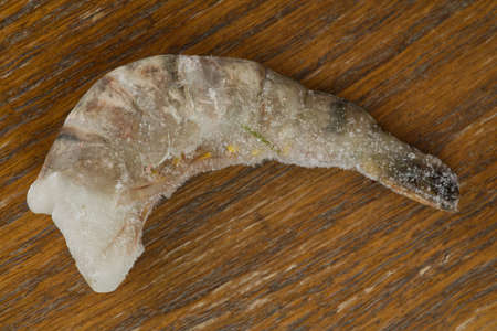 Frozen shrimp on a wooden background. Closeupの写真素材