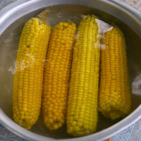 Boiled corn in a metal bowl. close.の写真素材