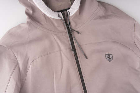 MOSCOW, RUSSIA-February 23, 2022: A Puma sweatshirt with a Ferrari badge on the chest. Top view. The zipper is fastened and the hood is visibleのeditorial素材