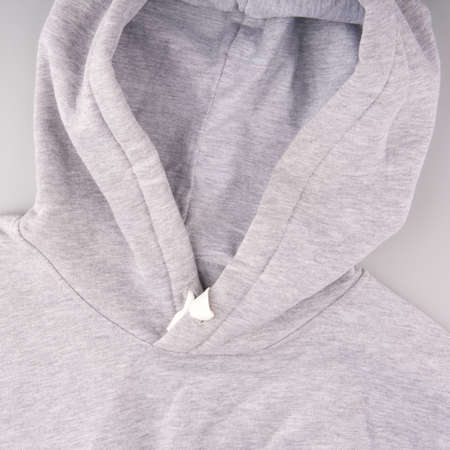 Sweatshirt with a hood of light color on a gray background closeupの写真素材