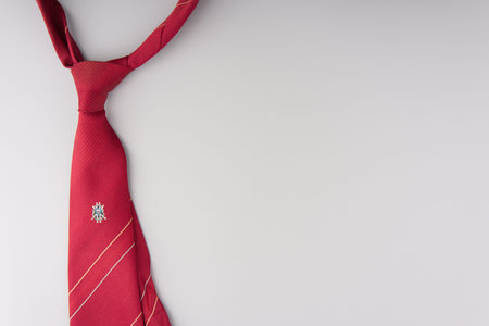 MOSCOW, RUSSIA-February 23, 2022: Branded red festive tie on a gray background. Top view. Space for textのeditorial素材