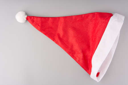 The red and white Santa Claus hat is completely on a gray backgroundの写真素材