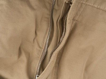The unbuttoned fly of light trousers. Closeupの写真素材