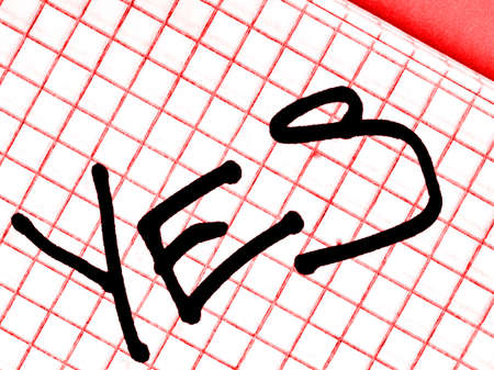 Yes is written on the red notebook sheet with a black marker. Closeupの写真素材