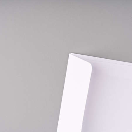 A white envelope on a gray background. closeup. top view. Place for text.の写真素材