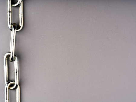 Large metal chain on a gray background. The concept of strength and power. Place for textの写真素材