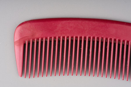Plastic hair comb on a gray background closeupの写真素材