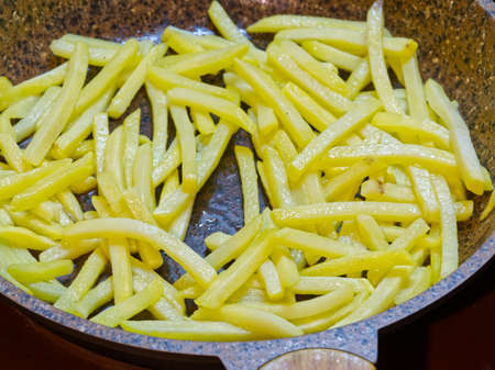 French fries fried in a frying pan at homeの写真素材