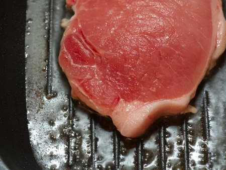 Raw steak in a pan closeup.の写真素材