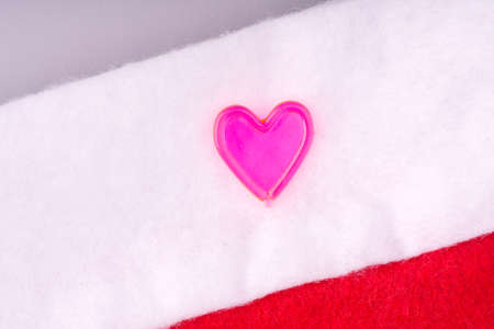 The heart lying on the hat of Santa Claus closeup. New Years Holidayの写真素材