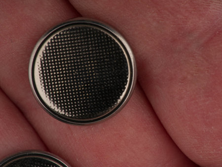 Round battery in hand. Closeupの写真素材