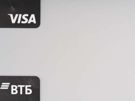MOSCOW, RUSSIA-February 23, 2022: Parts of two cards of Russian VTB banks that fell under the sanctions. On a gray background. Space for textのeditorial素材