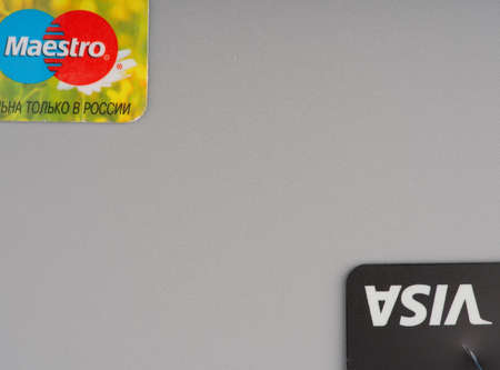 MOSCOW, RUSSIA-February 23, 2022: Parts of two credit cards on a gray background. Space for textのeditorial素材