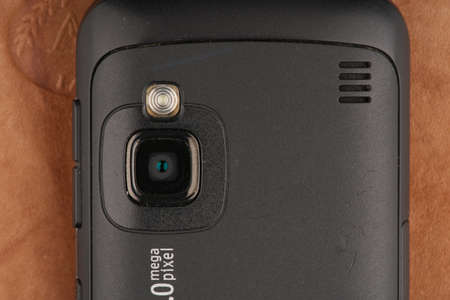MOSCOW, RUSSIA-February 23, 2022: An old Nokia mobile phone in close-up on a leather background. The phones camera is visibleのeditorial素材