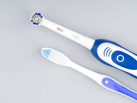 MOSCOW, RUSSIA-February 23, 2022: Branded electric toothbrush and regular on a light gray background. Closeupのeditorial素材