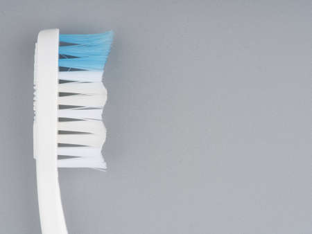 MOSCOW, RUSSIA-February 23, 2022: Branded toothbrush on a light gray background. Closeup. Space for textのeditorial素材