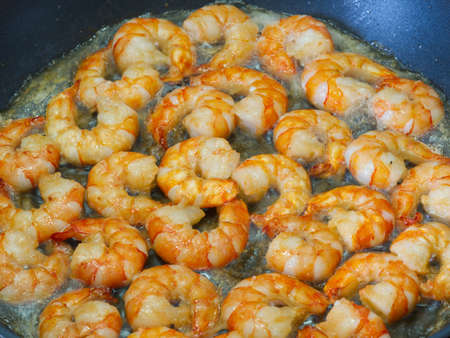 Fried shrimp in oil in a pan closeup . Restaurantの写真素材
